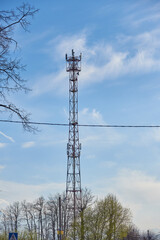 A cell tower against a cloudy sky.