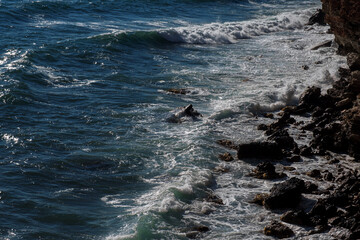 Ocean wave background breaking sea water rocky shore