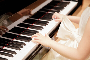 The princess in the dress plays the piano.