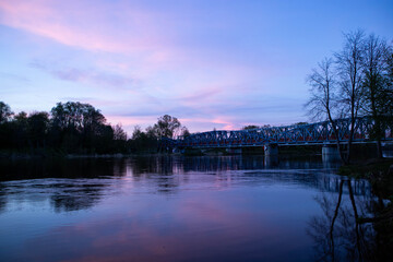 Spring sunset on the river, with blue skies, in a peaceful and quiet evening