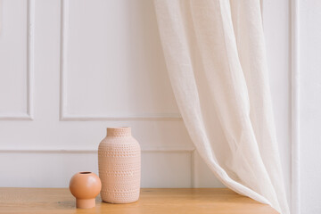 Fototapeta na wymiar Modern ceramic vases against molding wall background. Copy space, minimal art concept.