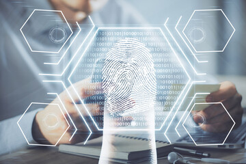 Double exposure of man's hands holding and using a digital device and fingerprint hologram drawing. Security concept.