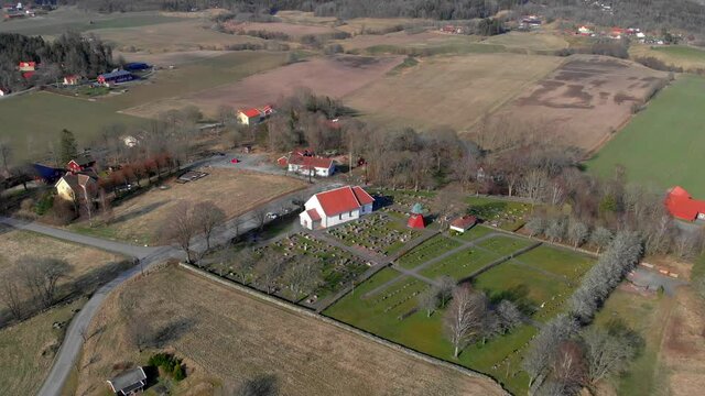 Aerial Shot Of Bergums Church And Cemetery, Traditional Rural Chapel And Village In Sweden