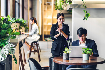 Group of professional multiethnic teamwork business discussing meeting strategy sharing idea with new startup project.Creative business people working with laptop computer in green plant terrace