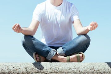 Fototapeta na wymiar Closeup of a man meditating and relaxing outdoors.