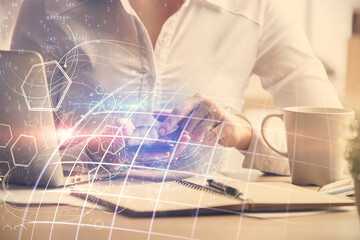 Double exposure of map sketch hologram and woman holding and using a mobile device.