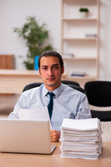 Young male employee unhappy with excessive work