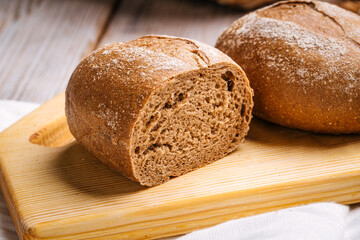 Closeup on loaves of rye bread on the wooden board