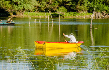 Novi Sad, Serbia - May 05. 2021: Recreational, traditional, sports, fishing on a sunny day, on the waters of the Danube tributary near Novi Sad, Serbia. 