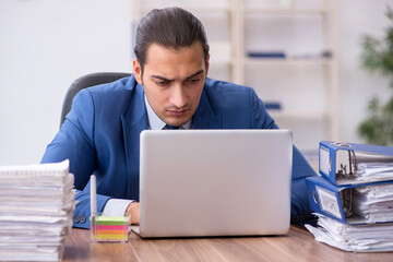 Young male employee unhappy with excessive work