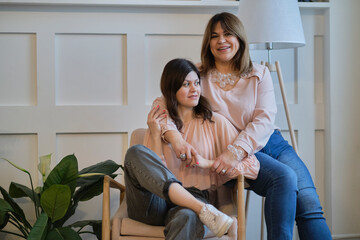 mother and adult daughter in the park, family portrait