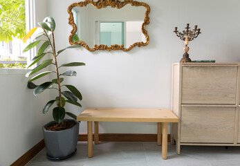 home foyer with wood bench and mirror, space for guest and shoe storage. - obrazy, fototapety, plakaty