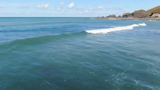 Aerial shot of the waves in the see at Spekes Mill coastal beach in Devon