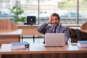 Fototapeta premium Young male employee working in the office