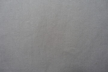 Fototapeta na wymiar Surface of simple light grey cotton fabric from above