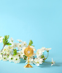 symbol of Catholic Sacrament of Communion, and flowers on blue background. Orthodox, Catholic,...