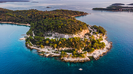 Aerial view of Zlatni Rt (Golden Cape) peninsula and Lone Bay near Rovinj, Istria, Croatia. Famous...