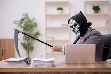 Devil businessman employee sitting at workplace