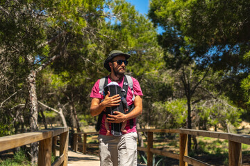 A young father on the path to Playa Moncayo on the Mediterranean Sea in Guardamar del Segura next to Torrevieja, Alicante. Community of Valencia. Spain
