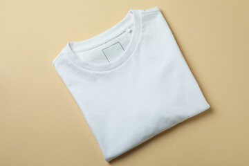 Blank sweatshirt on beige background, space for text