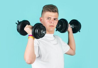 he is strong. concept of fitness. child workout with dumbbell. power and strength. weightlifting.