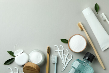 Oral care accessories on gray background, space for text