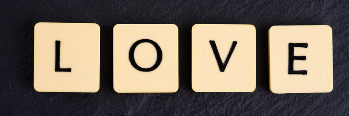 The word love on black background. Panoramic image