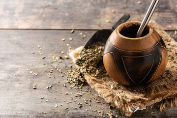 Traditional yerba mate tea on wooden table. Copy space