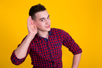 A handsome guy in a red shirt on a yellow background 