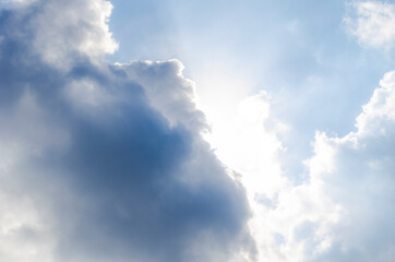 Sunshine throw white clouds in blue sky