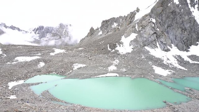 The Gauri Kund mountain lake during the ritual kora (yatra) around sacred Mount Kailash. Ngari scenery in West Tibet. Sacred place for Buddha pupils. Place of prayer, calm and meditation.