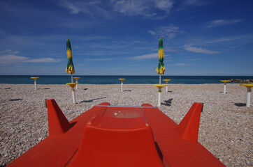 Red color rescue shoe on the beach.