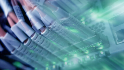 Close up fiber optic and hub telecommunication in server room.	
