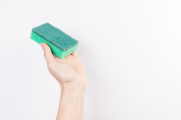 Sponge for washing dishes in female hand. Woman's hand gesture or sign isolated on white. A hand holds a sponge for washing and cleaning dishes
