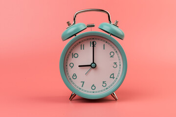 Old clock isolated on a pink background with space for text. Concept of time