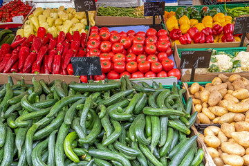 Cucumber, tomatoes and potatoes for sale at a market