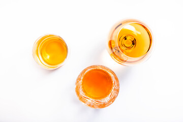 Strong alcoholic drinks, spirits and distillates in glasses: vodka, cognac, scotch, whiskey and other. White background. Hard light