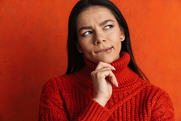 Young hispanic puzzled woman thinking and looking aside
