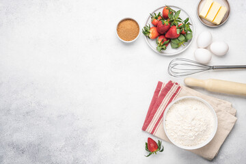 Baking strawberry pie white background. Flour, butter, eggs and kitchen utensils on white stone table. Empty space for menu or recipe. View from above
