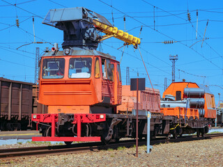 Railway crane. Loading locomotive with the diesel engines. Small diesel locomotive.