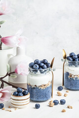 Blueberry butterfly pea flower parfait in glass jars