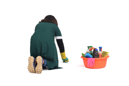 Rear View Of A Woman Scrubbing The Floor On Her Knees Isolated On White