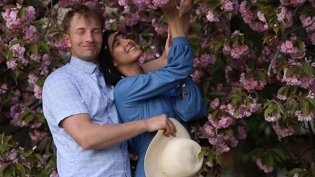 couple in the garden. Couple in love. Sensual. Love photo. Flowers background. 