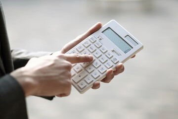 Close up of businessman using calculator