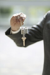 Close up of businessman holding lock and key  