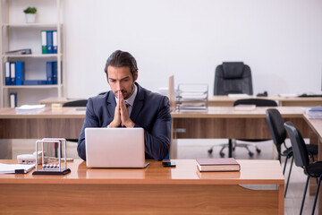 Young man businessman employee sitting in the office