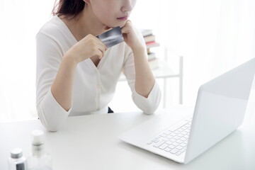 Young woman shopping online with credit card