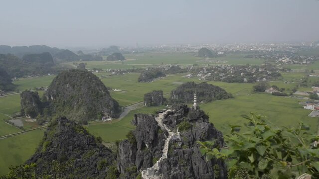 Top view of Hang Mua (Mua Cave) in NinhBinh with spectacular panoramic view of rice fields, limestone mountains. Tamcoc view from Mua cave. Ngo Dong river in Tam Coc, Vietnam.