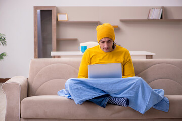 Young man freelancer suffering at home