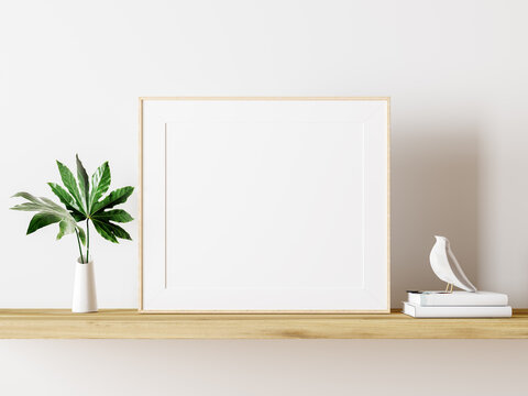 Empty white mock up picture frame on wooden shelf with green plant decoration 3D Rendering, 3D Illustration